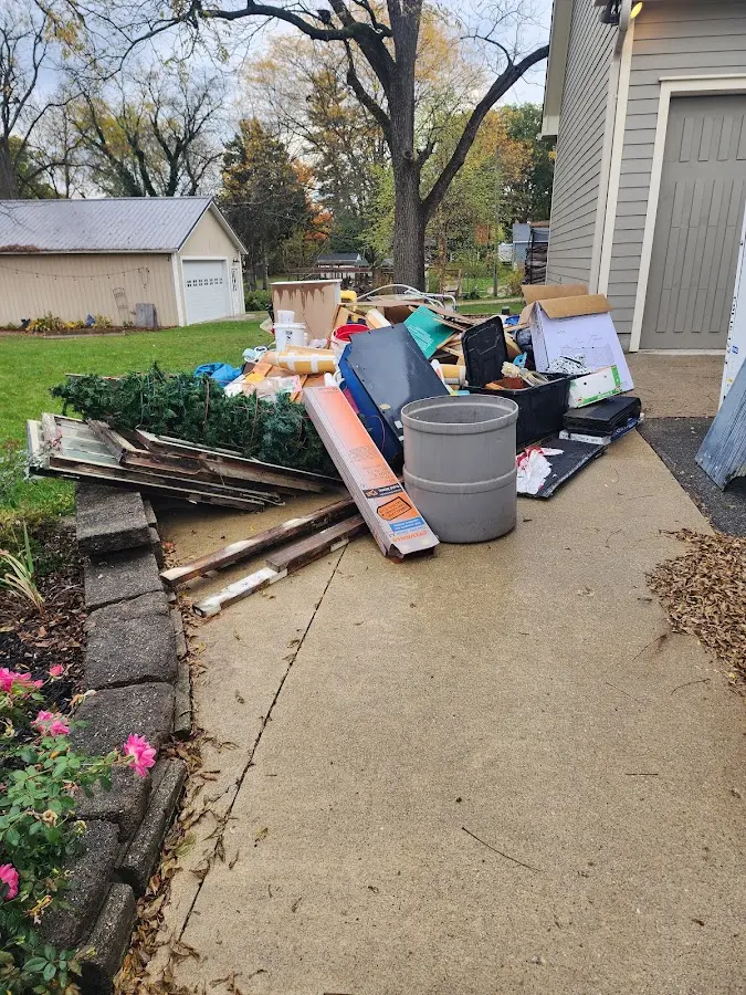 Dumpster being loaded with debris for 10 Yard Dumpster Rental in Alexandria